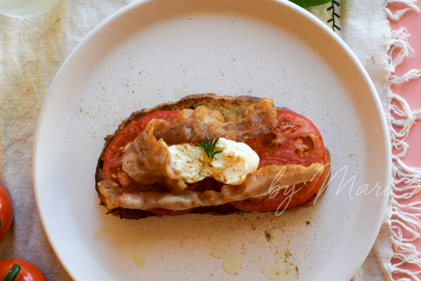 Гренки с томатами, моцареллой и беконом на тарелке